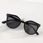 Women's sunglasses with matte black frames and gold accents